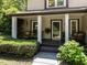 Inviting front porch with seating and lush greenery, offering a welcoming entrance to the home at 1514 John Jones Rd, Bahama, NC 27503