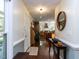 Inviting hallway with hardwood floors and views into the kitchen, enhanced by stylish decor and ample lighting at 1514 John Jones Rd, Bahama, NC 27503