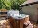 Close-up of backyard hot tub on a wood deck with privacy fencing at 1514 John Jones Rd, Bahama, NC 27503