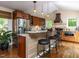 Spacious kitchen with custom cabinets, stainless steel appliances, granite countertops, and a stylish breakfast bar at 1514 John Jones Rd, Bahama, NC 27503