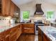 Beautiful kitchen featuring wood cabinets, granite countertops, stainless steel appliances, and decorative backsplash at 1514 John Jones Rd, Bahama, NC 27503