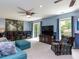 Cozy living room featuring comfortable seating, a large TV, and natural light at 1514 John Jones Rd, Bahama, NC 27503