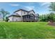 Beautiful backyard with a screened deck area and a well-manicured lawn for outdoor enjoyment at 1540 Sandybrook Ln, Wake Forest, NC 27587