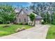 Brick two-story home with mature landscaping and a long driveway at 1540 Sandybrook Ln, Wake Forest, NC 27587