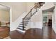 Elegant foyer with hardwood floors, paneled walls, a staircase with wrought iron balusters, and abundant natural light at 1540 Sandybrook Ln, Wake Forest, NC 27587