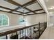 Second floor view of the foyer with coffered ceilings, large windows and wrought iron railing at 1540 Sandybrook Ln, Wake Forest, NC 27587