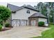 Spacious three-car garage featuring stylish doors and a concrete driveway, offering ample parking at 1540 Sandybrook Ln, Wake Forest, NC 27587
