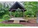 Charming backyard gazebo with wooden swing, perfect for relaxing and enjoying the outdoors at 1540 Sandybrook Ln, Wake Forest, NC 27587