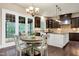 Eat-in kitchen area includes a chandelier and French doors to the home's outdoor space at 1540 Sandybrook Ln, Wake Forest, NC 27587