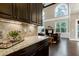 Gourmet kitchen featuring granite countertops, tile backsplash, and views into the living room at 1540 Sandybrook Ln, Wake Forest, NC 27587