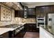 Gourmet kitchen features stainless steel appliances, dark wood cabinets, and tiled backsplash at 1540 Sandybrook Ln, Wake Forest, NC 27587