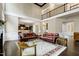 Open-concept living room with hardwood floors, fireplace and view into the kitchen and upstairs at 1540 Sandybrook Ln, Wake Forest, NC 27587