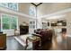 Bright, open living room with high ceilings, a fireplace, hardwood floors, and seamless flow to the kitchen at 1540 Sandybrook Ln, Wake Forest, NC 27587