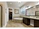 This bathroom offers tile floors, a corner soaking tub and a vanity with double sinks at 1540 Sandybrook Ln, Wake Forest, NC 27587