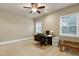 Home office featuring two windows, a ceiling fan and a built-in desk at 1540 Sandybrook Ln, Wake Forest, NC 27587