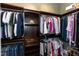 A walk-in closet with wood shelving and hanging storage for clothes, shoes, and accessories at 1540 Sandybrook Ln, Wake Forest, NC 27587