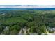 Extensive green forests surround well-spaced homes in this scenic aerial view of the neighborhood at 1605 Hall Blvd, Garner, NC 27529