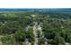 Aerial view showcases a winding road and houses nestled among lush green trees in a suburban neighborhood at 1605 Hall Blvd, Garner, NC 27529