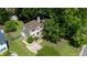 Aerial view of a suburban home with lush landscaping, a driveway, and mature trees at 1605 Hall Blvd, Garner, NC 27529