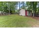 Spacious backyard with storage shed, play area, and lush greenery, ideal for outdoor activities at 1605 Hall Blvd, Garner, NC 27529