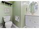 Cozy bathroom features a modern toilet and vanity with a decorative mirror and ample lighting at 1605 Hall Blvd, Garner, NC 27529