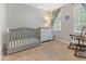 Cozy Bedroom with a crib, dresser, and a comfortable rocking chair at 1605 Hall Blvd, Garner, NC 27529