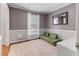 Comfortable bedroom with hardwood floors, neutral paint, a large window, and cozy rug at 1605 Hall Blvd, Garner, NC 27529