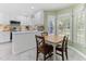Bright dining area with white cabinets, updated appliances, and a bay window offering abundant natural light at 1605 Hall Blvd, Garner, NC 27529