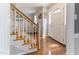 Inviting foyer with hardwood floors, staircase with carpet, and a view into the light-filled living spaces at 1605 Hall Blvd, Garner, NC 27529