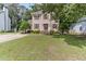 Charming two-story home with cream siding, red shutters, a white railed porch, and a well-manicured lawn at 1605 Hall Blvd, Garner, NC 27529
