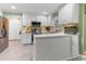 Bright eat-in kitchen features white cabinets, stainless steel appliances, and modern countertops at 1605 Hall Blvd, Garner, NC 27529