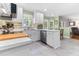 Eat-in kitchen features white cabinets, stainless steel appliances, and views of the backyard at 1605 Hall Blvd, Garner, NC 27529