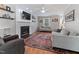 Comfortable living room featuring a fireplace with mantel, hardwood floors, ceiling fan, and neutral decor at 1605 Hall Blvd, Garner, NC 27529