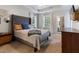 Spacious main bedroom with large bed, windows, and dresser, offering plenty of storage at 1605 Hall Blvd, Garner, NC 27529