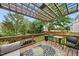 Relaxing back deck under a pergola with outdoor dining and a view of the private backyard at 1605 Old London Way, Apex, NC 27523