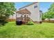 Spacious backyard featuring a deck with pergola and a well-maintained lawn and landscaping at 1605 Old London Way, Apex, NC 27523