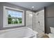 Bathroom with a soaking tub and a separate glass-enclosed shower provides a spa-like experience at 1605 Old London Way, Apex, NC 27523