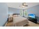 Well-lit bedroom with a large window and TV, creating a relaxing and comfortable living space at 1605 Old London Way, Apex, NC 27523