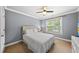This is a cozy bedroom featuring a plush bed, ample natural light, and a serene atmosphere at 1605 Old London Way, Apex, NC 27523