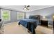 Serene bedroom featuring a ceiling fan, neutral carpet, and two windows that offer natural light at 1605 Old London Way, Apex, NC 27523