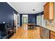 Open dining area with hardwood floors and stainless steel appliances in the adjacent kitchen at 1605 Old London Way, Apex, NC 27523