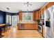 Spacious kitchen featuring stainless steel appliances, granite countertops, and hardwood flooring at 1605 Old London Way, Apex, NC 27523