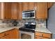 This charming kitchen has stainless steel appliances and granite countertops, adding to its appeal at 1605 Old London Way, Apex, NC 27523
