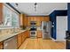 Modern kitchen featuring stainless steel appliances, granite countertops, and hardwood floors at 1605 Old London Way, Apex, NC 27523