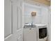 Bright laundry room featuring modern appliances and ample storage space in a well-lit closet at 1605 Old London Way, Apex, NC 27523