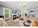 Comfortable living room featuring a fireplace, ceiling fan, and seamless open-concept design at 1605 Old London Way, Apex, NC 27523