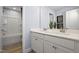 Well-lit bathroom featuring double sinks, white cabinets, and a shower/tub combination at 168 Copperleaf Court, Franklinton, NC 27525