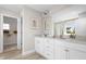Modern bathroom featuring double sink vanity, neutral walls, tile floor, and a walk-in closet at 168 Copperleaf Court, Franklinton, NC 27525
