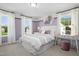 Bright bedroom with large windows, neutral-toned carpet, and a decorative headboard at 168 Copperleaf Court, Franklinton, NC 27525
