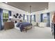 A light and airy main bedroom showcasing tray ceilings, light carpet and large windows with elegant blue accents at 168 Copperleaf Court, Franklinton, NC 27525